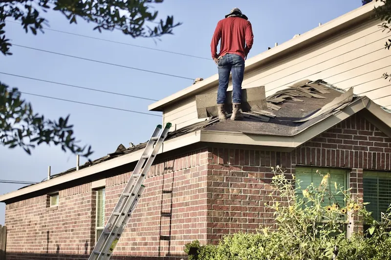 Professional roofer working on a residential roof in Allen